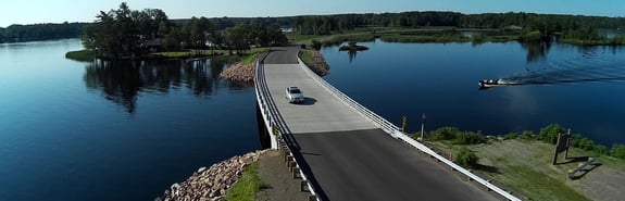 Car crossing over lake on a bridge