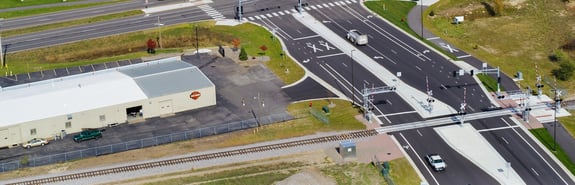 Aerial view of road and train track intersection