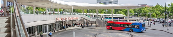 Denver RTD station with people and bus