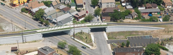 Overhead view of pedestrian and cycling bridge crossing two busy roadways