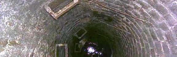 Looking down into a sewer pipe